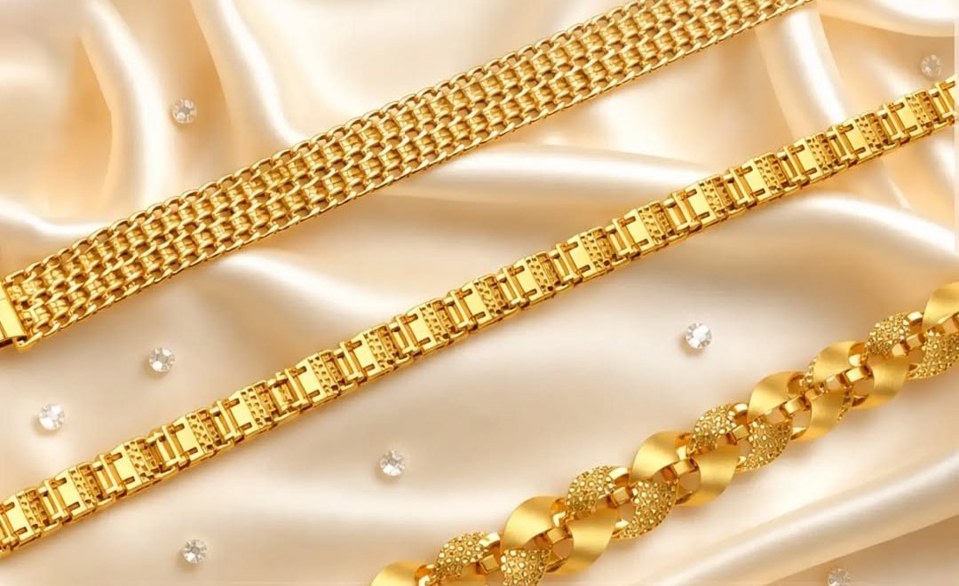 Three gold bracelets on ivory satin